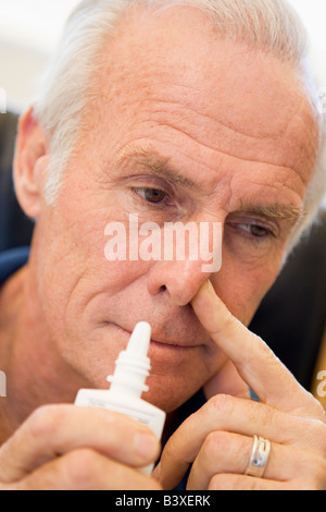 Senior Man Using Nasal Spray Stock Photo