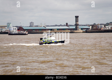 Police boat on the Mersey River with Liverpool behind taking part in the Tall Ships Race and Parade Stock Photo