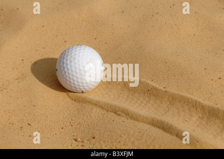 Golf ball in a bunker Stock Photo