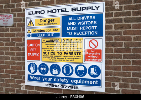 Entrance to construction site health and safety regulations warning sign on brick wall England UK United Kingdom Great Britain