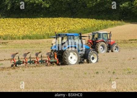 New Holland TS100 and Massey Ferguson tractors competing at ploughing match, Indre-et-Loire, France. Stock Photo