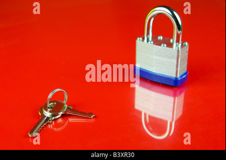 A padlock isolated against a red background Stock Photo