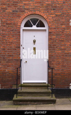 White front door with glazed semi-circular fanlight of townhouse in Ludlow Shropshire England UK