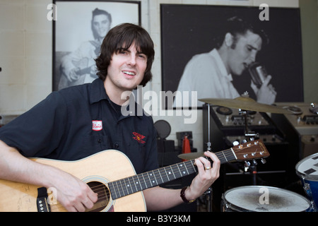 Young man demonstrates acoustic guitar technique at Sun Studio Memphis Tennessee USA. Stock Photo