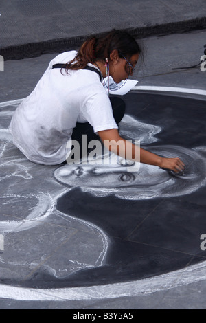 A painter (artist) woman is painting on the street in Florence (Firenze), Italy August 2008 Stock Photo