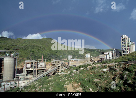 Rainbow over cement plant in Darlaghat, Himachal Pradesh, India Stock Photo