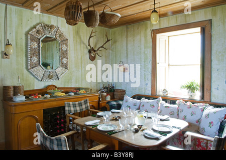 Scotland, Inner Hebrides, Jura. The dining room set for lunch in GlenBatrick Lodge. The lodge overlooks the white sandy shore of Loch Tarbert on the west side of Jura. Beautifully isolated the lodge is only accessible by boat or a five hour walk. Stock Photo