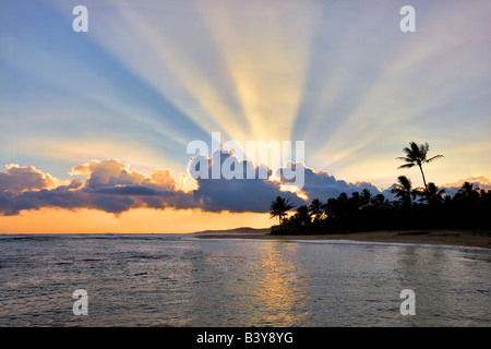 Sunset at Poipu Beach with rays of light Kauai Hawaii Stock Photo