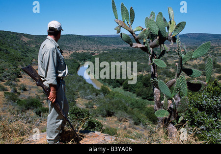 South Africa, Eastern Cape, Kwandwe Private Game Reserve. Ranger looks over The Great Fish River Stock Photo
