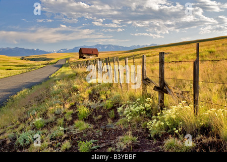 Pasture in Zumwalt Prairie with fence barn and Wallowa Mountains Oregon