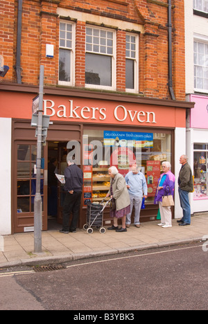 People queing to buy bread at the Bakers Oven bakery in Beccles,Suffolk,Uk Stock Photo