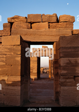 Sudan, Khartoum, Naga. Bathed in early morning sunlight with a full moon still evident in the sky, this ruins of a temple dedicated to Amon is one of the four temples situated beside an important wadi at Naga some 30 km from the Nile. Amon was revered in both Egypt and the Kingdom of Cush as king of the Gods.Discovered in 1821, the temples have been dated between 1BC and 1AD. They are fine examples of Afro-Egyptian architecture and are attributed to the Meroitic culture that flourished at that time.. Stock Photo