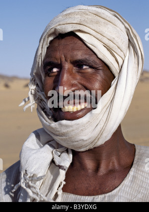 Sudan, Sahara Desert, Qubbat Selim. A Nubian man wearing a white turban smiles broadly at his friend. Stock Photo
