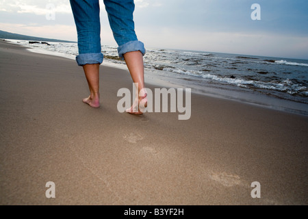 Walking along the Lake Superior shoreline near Silver City Michigan at sunset (MR) Stock Photo