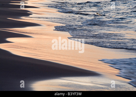 Sunset color reflects in the sandy shore of Lake Superior near Silver City Michigan Stock Photo