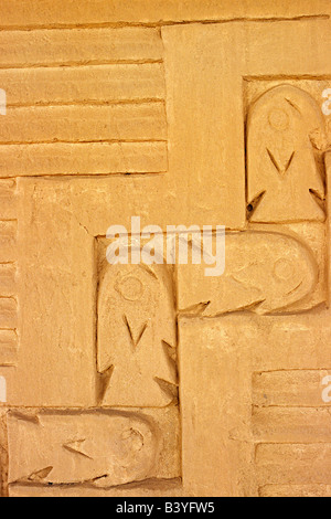 Peru, Trujillo, Chan Chan. Adobe wall frieze incorporating a fish and wave design in the Audience Rooms of the Tschudi Complex - one of the Royal Compounds at the Chimu site of Chan Chan, near Trujillo in northern Peru. Stock Photo