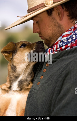 USA, Oregon, Seneca, Ponderosa Ranch. Close-up of a cowboy holding his dog.  (MR) (PR) Stock Photo