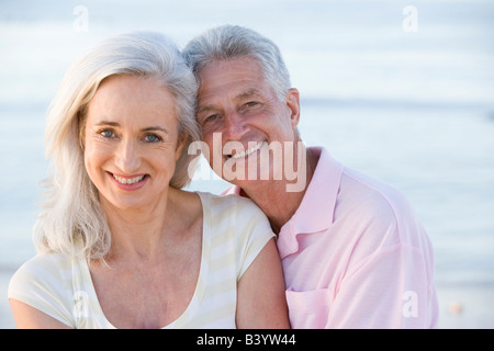 Couple at the beach smiling Stock Photo