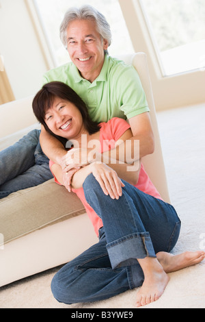 Couple relaxing in living room and smiling Stock Photo