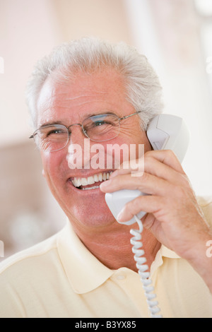 Man using telephone and smiling Stock Photo