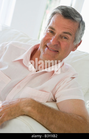 Man sitting in living room smiling Stock Photo