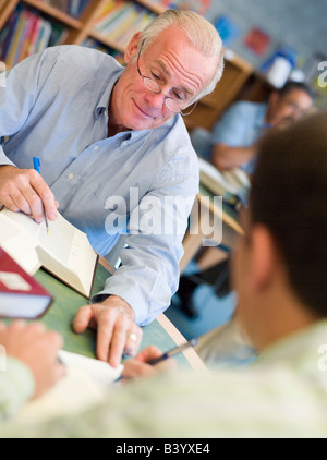 Two men in library with notepads talking (selective focus) Stock Photo