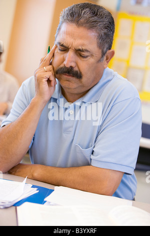 Adult student in class thinking Stock Photo