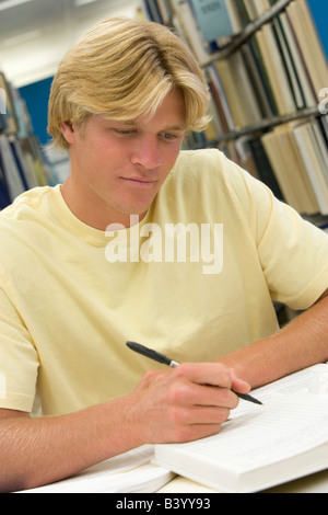 Man sitting in library studying Stock Photo