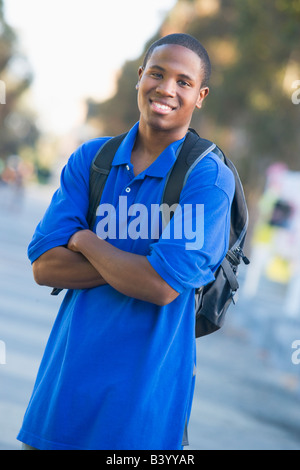 Man standing outdoors smiling (selective focus) Stock Photo