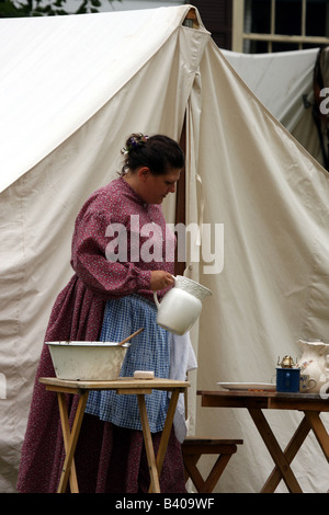 A women holding a water pitcher dressed and camping during the Civil War Encampment Reenactment Stock Photo