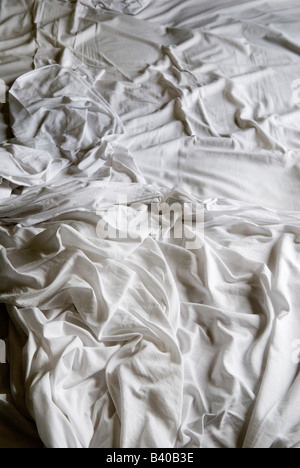 Crumpled bed sheets an unmade bed white bed sheets frowzled HOMER SYKES Stock Photo