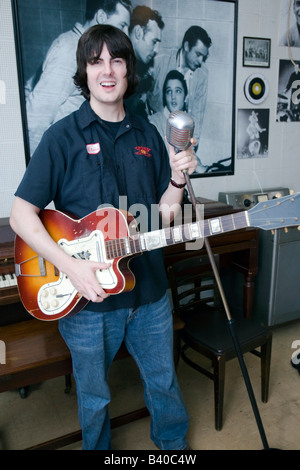 Young man demonstrates semi acoustic guitar technique at Sun Studio Memphis Tennessee USA. Stock Photo