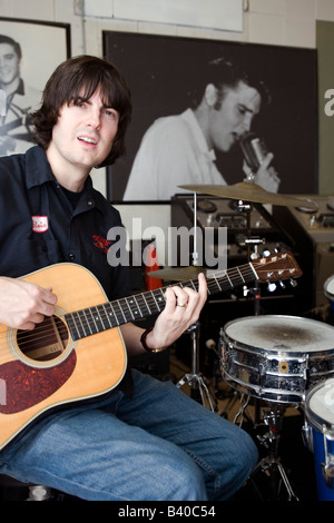 Young man demonstrates acoustic guitar technique at Sun Studio Memphis Tennessee USA. Stock Photo
