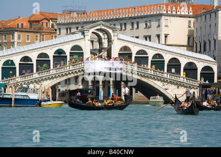 Taking a Gondola ride near the Rialto Bridge in Venice Italy Stock Photo