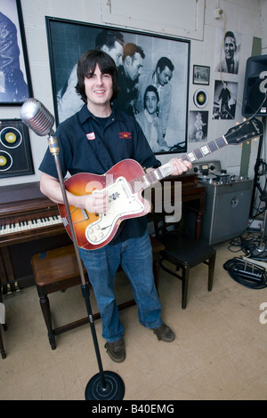 Young man demonstrates semi acoustic guitar technique at Sun Studio Memphis Tennessee USA. Stock Photo
