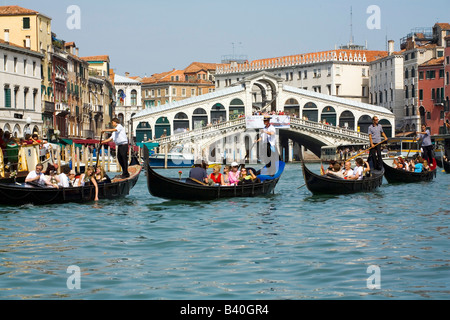 Taking a Gondola ride near the Rialto Bridge in Venice Italy Stock Photo