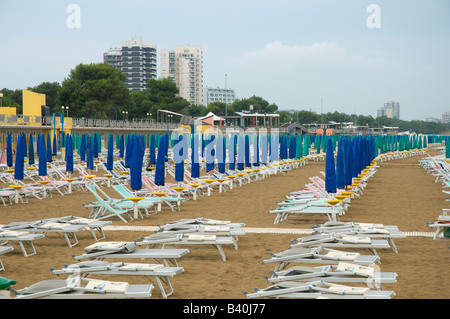 the sunbeds and umbrellas closed in the beach of Lignano Sabbiadoro, Italy Stock Photo