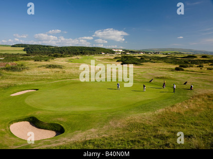 Golfers on the 13th green at Turnberry Golf Club Ailsa course and the Turnberry hotel in the distance  Ayrshire Scotland Stock Photo