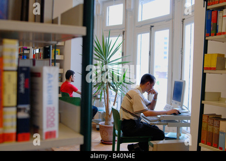 Two young Egyptian students are using the computer facilities in a library Stock Photo