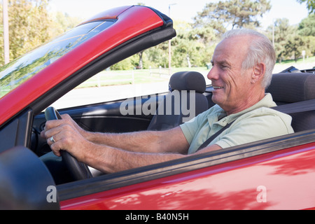 Man in convertible car smiling Stock Photo