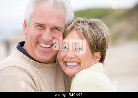 Couple at the beach smiling Stock Photo
