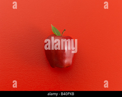 Red apple on red background Stock Photo