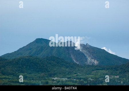 Mount Sibayak on the Karo Plateau with blue sky at daylight Stock Photo
