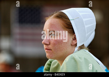 Mennonite Teenage Girl at Heritage Festival with American Flag Behind Lanesville Indiana Stock Photo