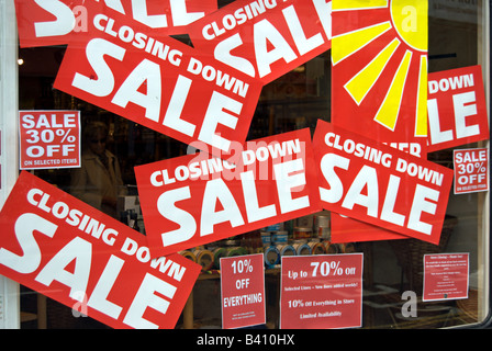 red and white closing down sale signs in a shop window in kingston upon thames, surrey, england Stock Photo