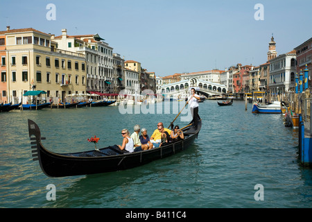 Taking a Gondola ride near the Rialto Bridge in Venice Italy Stock Photo