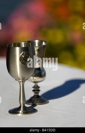 USA, Seattle, Washington, Silver Kiddush Wine Cups standing on a white table cloth. Stock Photo