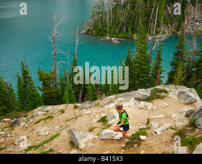 Washington, Cascade Mountains, Leavenworth.  A female trail runner above Colchuck Lake.  (MR) Stock Photo