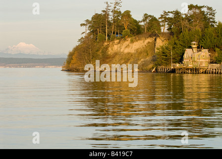 USA, WA, Whidbey Island, Coupeville. Penn Cove home on dock. Mt Baker on mainland beyond. Stock Photo