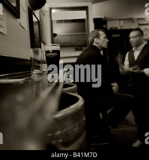 A pint of Guiness and two friends at a London pub Stock Photo